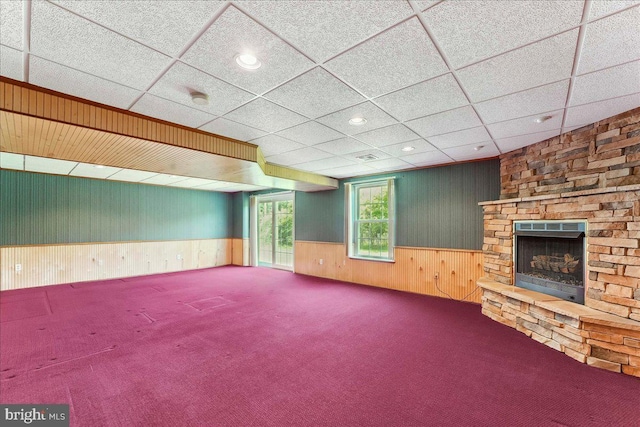 916 E Fox Hound Chase Chase, Glen Mills, PA 19342 - unfurnished living room with wood walls, wainscoting, carpet floors, a stone fireplace, and recessed lighting