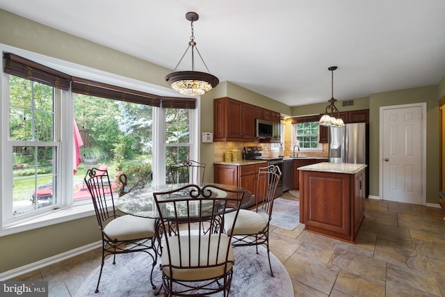 1024 Page Ct, Herndon, VA 20170 - dining area with baseboards, light stone finish flooring, and a chandelier