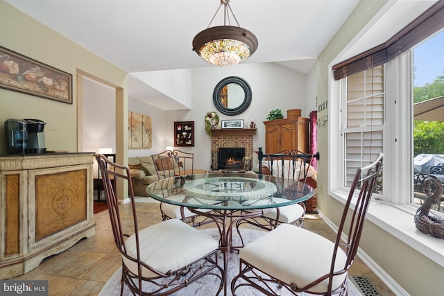 1024 Page Ct, Herndon, VA 20170 - dining area with a fireplace, lofted ceiling, and baseboards