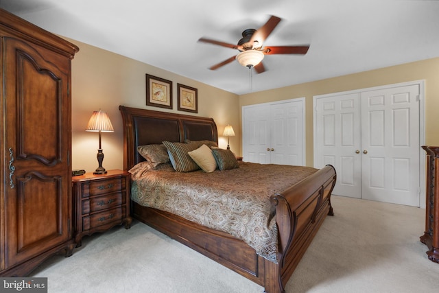 1024 Page Ct, Herndon, VA 20170 - bedroom with light colored carpet, multiple closets, and a ceiling fan