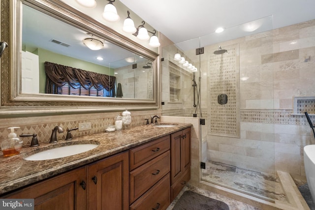 1024 Page Ct, Herndon, VA 20170 - full bathroom featuring a walk in shower, double vanity, a freestanding tub, decorative backsplash, and tile walls