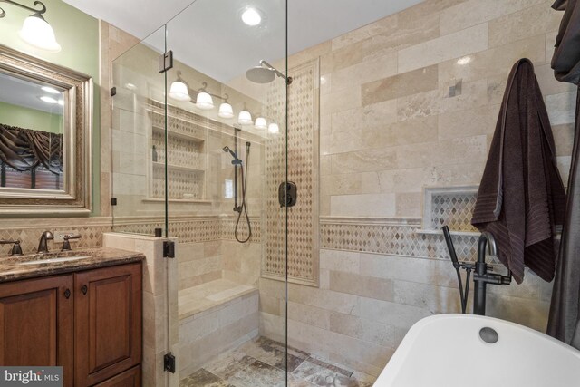 1024 Page Ct, Herndon, VA 20170 - full bath featuring tile walls, a soaking tub, a stall shower, and vanity