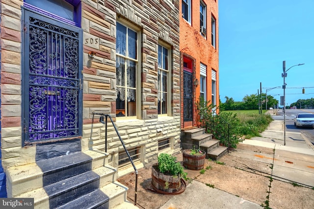505 N Schroeder St, Baltimore, MD 21223 - view of side of property with stone siding and entry steps