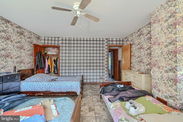 505 N Schroeder St, Baltimore, MD 21223 - tiled bedroom with wallpapered walls, a walk in closet, ceiling fan, and a closet