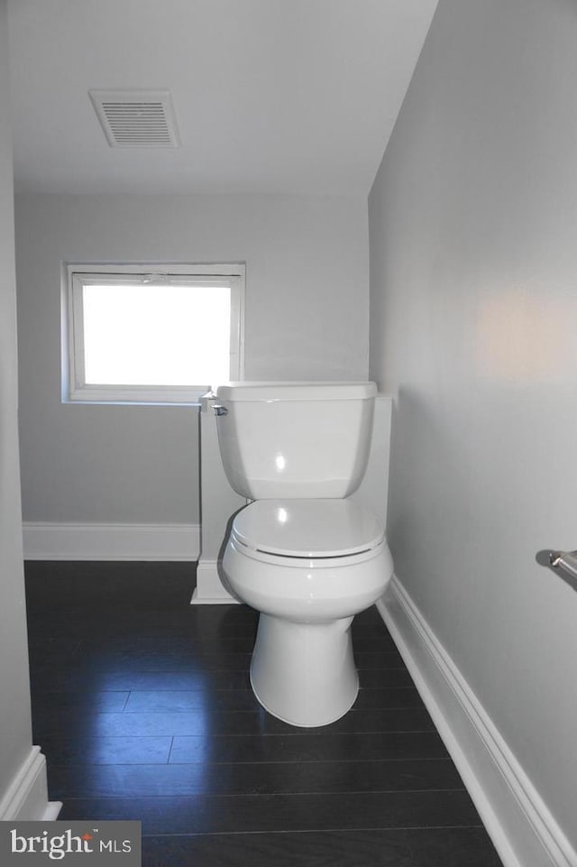 329 S Durham St, Baltimore, MD 21231 - bathroom featuring toilet, baseboards, and wood finished floors