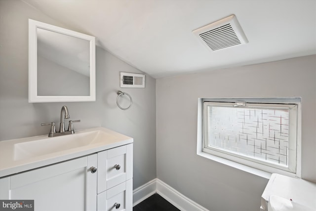 329 S Durham St, Baltimore, MD 21231 - bathroom featuring lofted ceiling, vanity, and baseboards