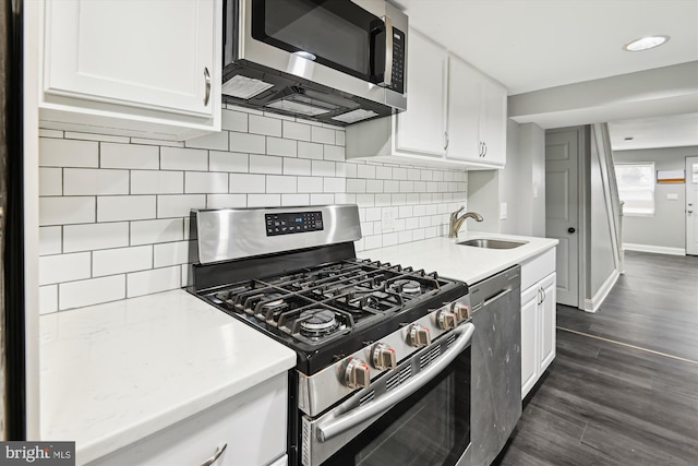 329 S Durham St, Baltimore, MD 21231 - kitchen featuring appliances with stainless steel finishes, a sink, white cabinetry, and tasteful backsplash