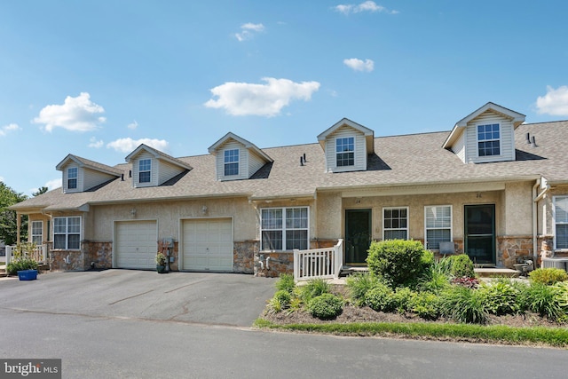 24 Stuart Dr Unit 24, Norristown, PA 19401 - view of front of home with stone siding, stucco siding, driveway, a garage, and roof with shingles