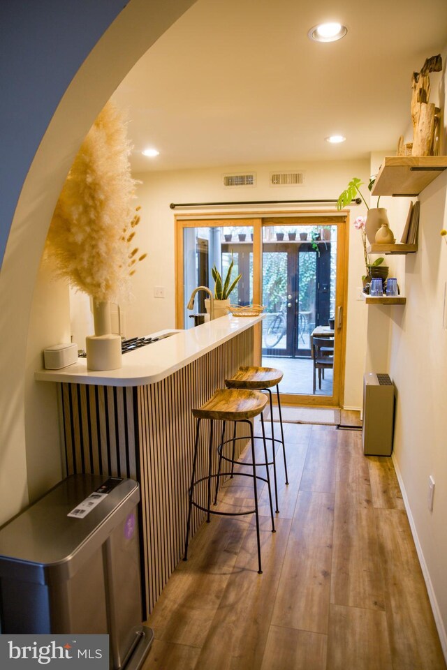 244 10th St NE, Washington, DC 20002 - bar with arched walkways, wood finished floors, recessed lighting, baseboards, and french doors