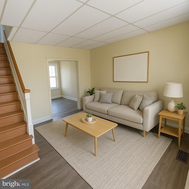 2926 N Stillman St, Philadelphia, PA 19132 - living area featuring a paneled ceiling, dark wood finished floors, baseboards, and stairs