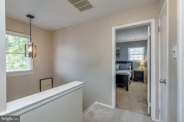 139 Shreve St, Mount Holly, NJ 08060 - corridor featuring light carpet, healthy amount of natural light, a chandelier, and baseboards