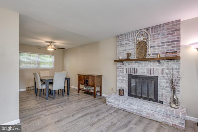 139 Shreve St, Mount Holly, NJ 08060 - dining area with wood finished floors, ceiling fan, baseboards, baseboard heating, and a fireplace