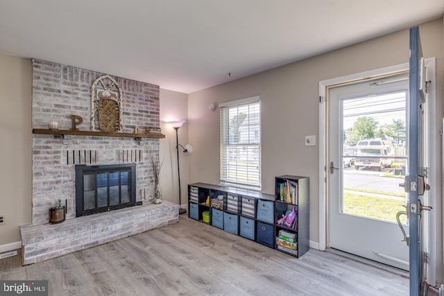 139 Shreve St, Mount Holly, NJ 08060 - living room with wood finished floors, a brick fireplace, and baseboards