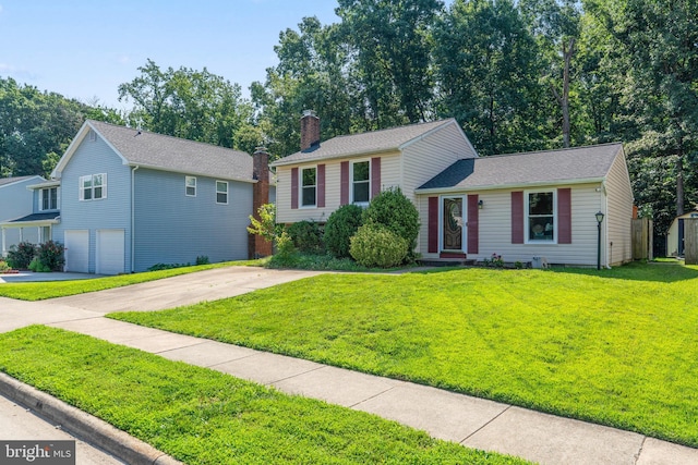 7627 Fallswood Way, Lorton, VA 22079 - tri-level home with a front yard, an attached garage, concrete driveway, and a chimney