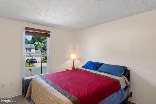 7627 Fallswood Way, Lorton, VA 22079 - bedroom with wood finished floors and a textured ceiling