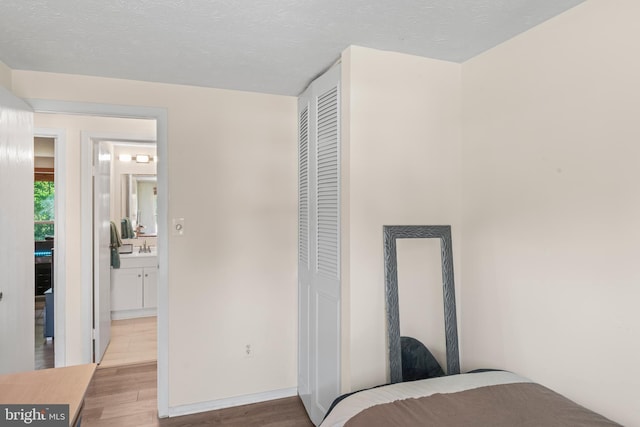 7627 Fallswood Way, Lorton, VA 22079 - bedroom with wood finished floors, a closet, and connected bathroom
