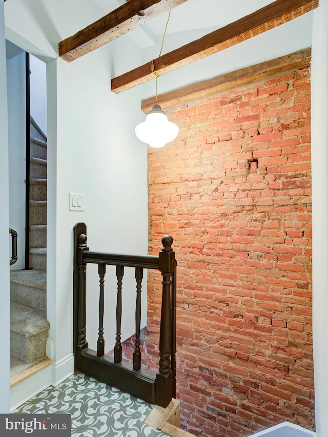 1510 N Leithgow St, Philadelphia, PA 19122 - stairway featuring beam ceiling, brick wall, and baseboards