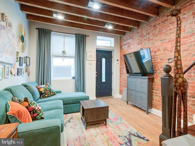 1510 N Leithgow St, Philadelphia, PA 19122 - living room featuring beamed ceiling, light wood-type flooring, baseboards, and brick wall