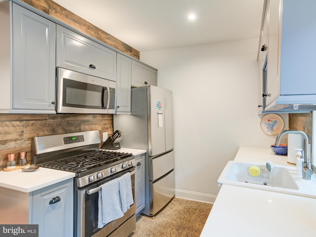 1510 N Leithgow St, Philadelphia, PA 19122 - kitchen featuring stainless steel appliances, a sink, tasteful backsplash, baseboards, and light countertops