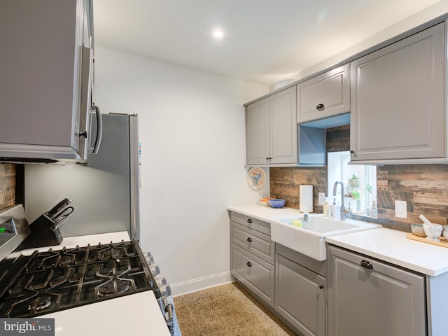 1510 N Leithgow St, Philadelphia, PA 19122 - kitchen with gray cabinets, stainless steel gas range oven, a sink, backsplash, and recessed lighting
