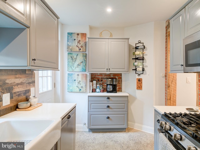 1510 N Leithgow St, Philadelphia, PA 19122 - kitchen featuring baseboards, appliances with stainless steel finishes, gray cabinetry, and light countertops