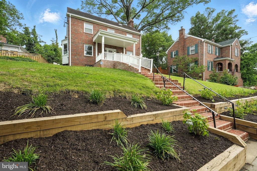 1821 Shepherd St NE, Washington, DC 20018 - view of front facade with brick siding, a front yard, and a porch
