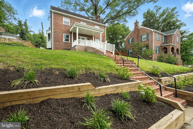 1821 Shepherd St NE, Washington, DC 20018 - view of front facade with brick siding, a front yard, and a porch