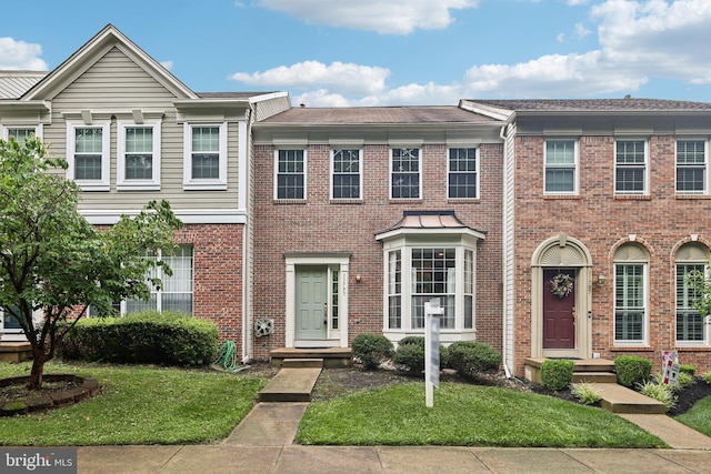 11793 Nates Pl, Woodbridge, VA 22192 - townhome / multi-family property with a front lawn and brick siding