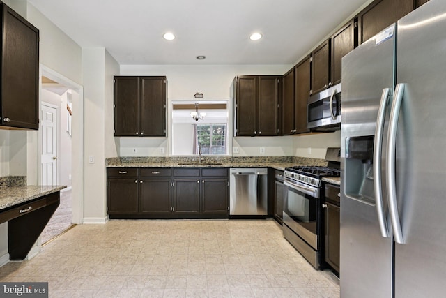 11793 Nates Pl, Woodbridge, VA 22192 - kitchen with stainless steel appliances, light stone counters, dark brown cabinetry, and recessed lighting