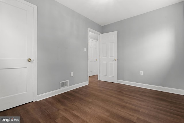 140 Wilmington Pl SE, Washington, DC 20032 - unfurnished bedroom with baseboards and dark wood-style flooring