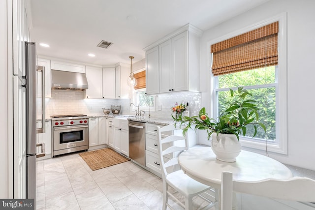 512 Piccadilly Rd, Baltimore, MD 21204 - kitchen with extractor fan, appliances with stainless steel finishes, tasteful backsplash, white cabinets, and light stone countertops