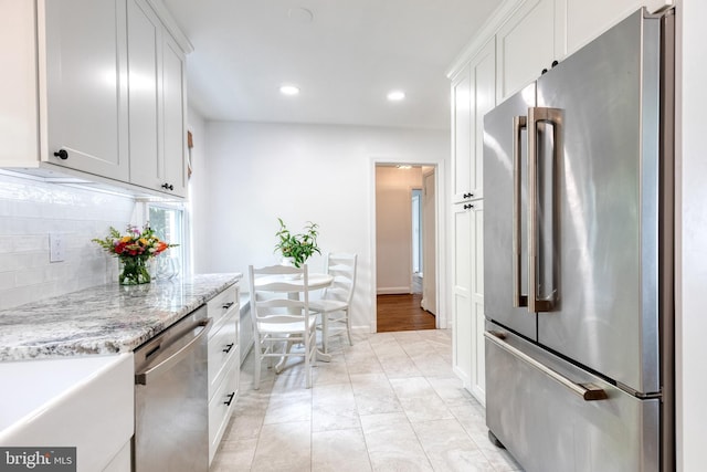 512 Piccadilly Rd, Baltimore, MD 21204 - kitchen featuring appliances with stainless steel finishes, backsplash, white cabinetry, recessed lighting, and light stone countertops