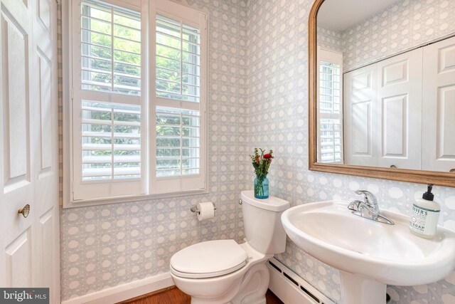 512 Piccadilly Rd, Baltimore, MD 21204 - bathroom featuring a baseboard radiator, toilet, wallpapered walls, and a sink