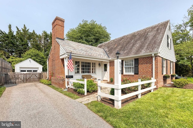 512 Piccadilly Rd, Baltimore, MD 21204 - view of front of home featuring brick siding, an outdoor structure, a detached garage, and a chimney