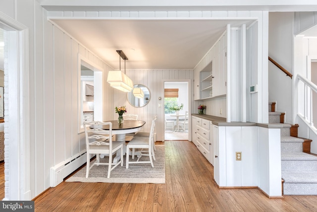512 Piccadilly Rd, Baltimore, MD 21204 - dining space featuring light wood finished floors, stairway, and wood walls