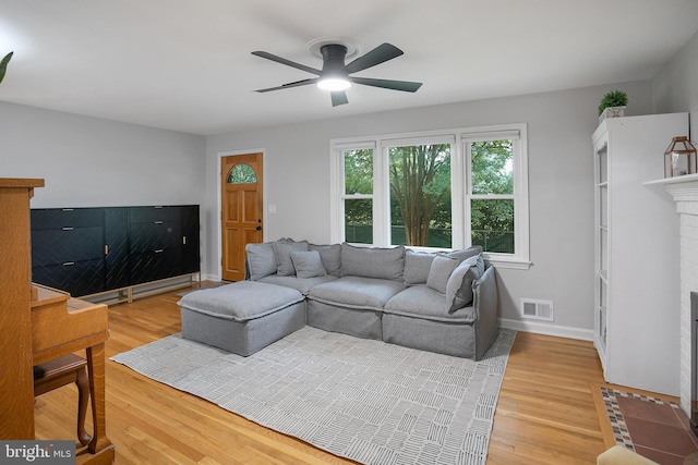 6001 Kroy Ct, Springfield, VA 22150 - living area featuring a ceiling fan, light wood-style flooring, and a brick fireplace