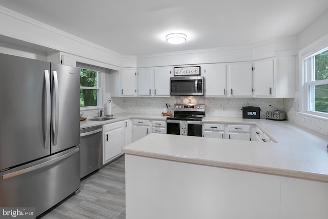 6001 Kroy Ct, Springfield, VA 22150 - kitchen with stainless steel appliances, backsplash, and white cabinetry