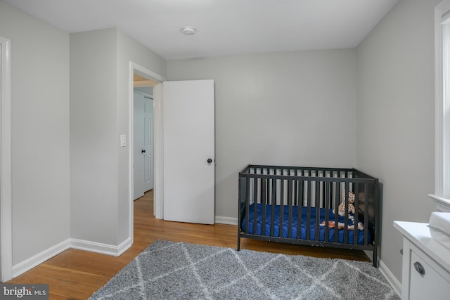 6001 Kroy Ct, Springfield, VA 22150 - bedroom with wood finished floors and a crib