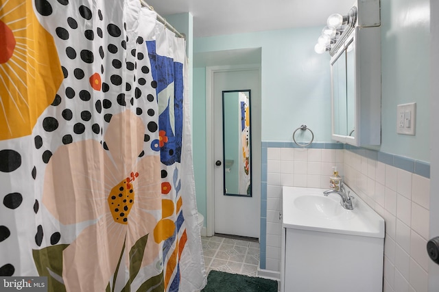 6001 Kroy Ct, Springfield, VA 22150 - bathroom with vanity, tile walls, curtained shower, a wainscoted wall, and tile patterned flooring