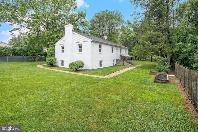 6001 Kroy Ct, Springfield, VA 22150 - view of home's exterior featuring a chimney, a fenced backyard, a garden, and brick siding