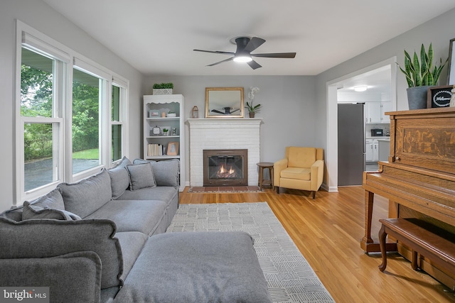 6001 Kroy Ct, Springfield, VA 22150 - living room with a ceiling fan, light wood finished floors, and a fireplace