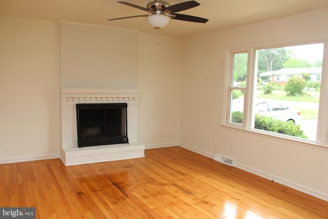 803 Grafton St, Fredericksburg, VA 22405 - unfurnished living room featuring light wood-style flooring, a brick fireplace, and ceiling fan