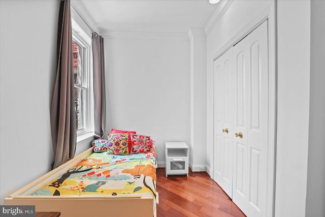 1832 Calvert St NW Unit 3, Washington, DC 20009 - bedroom with crown molding, multiple windows, wood finished floors, and a closet