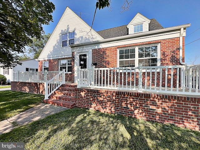 1045 S Bradford St, Dover, DE 19904 - view of front of property with brick siding, a front yard, a wooden deck, and roof with shingles