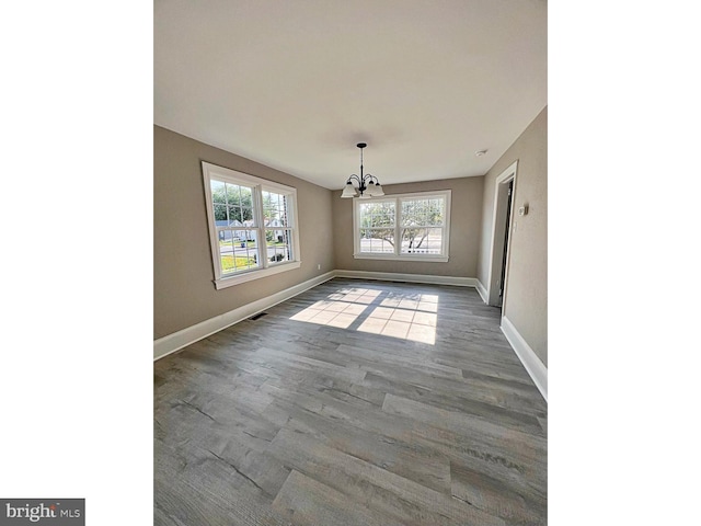 1045 S Bradford St, Dover, DE 19904 - unfurnished dining area featuring a chandelier and wood finished floors