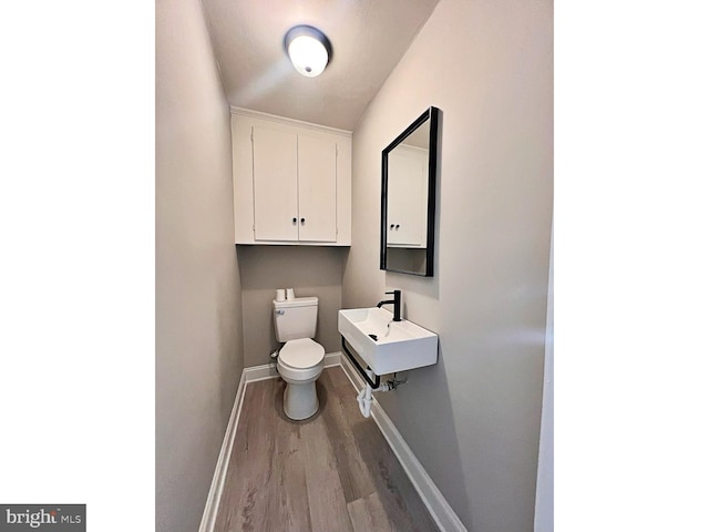 1045 S Bradford St, Dover, DE 19904 - half bath with wood finished floors and a sink