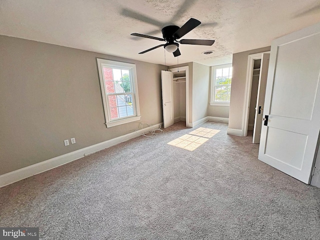 1045 S Bradford St, Dover, DE 19904 - unfurnished bedroom featuring multiple windows, carpet flooring, a textured ceiling, a ceiling fan, and a closet