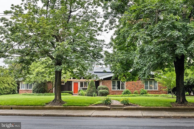 320 S Main St, Quakertown, PA 18951 - obstructed view of property featuring brick siding and a front yard
