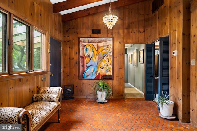 320 S Main St, Quakertown, PA 18951 - living area featuring healthy amount of natural light, wooden walls, beam ceiling, a chandelier, and high vaulted ceiling
