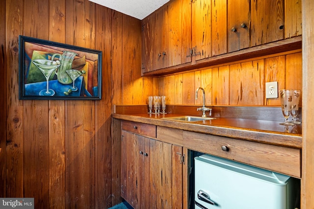320 S Main St, Quakertown, PA 18951 - indoor wet bar featuring wood walls, refrigerator, and white dishwasher